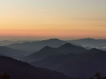 Scenic view of silhouette mountains against sky during sunrise 