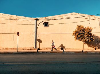 People on street against clear sky