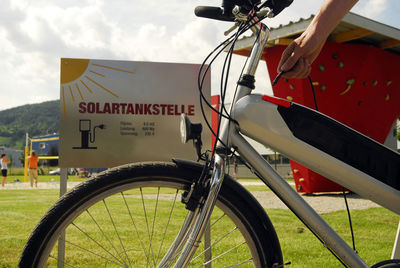 Close-up of bicycle sign against sky