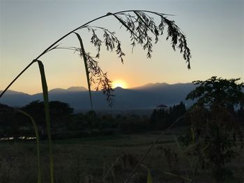 Silhouette landscape against sky during sunset