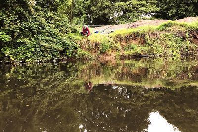 Reflection of boy in lake