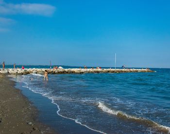 Scenic view of beach against blue sky