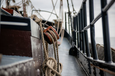 Rope hanging on railing at harbor