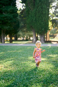 Full length of cute girl on field