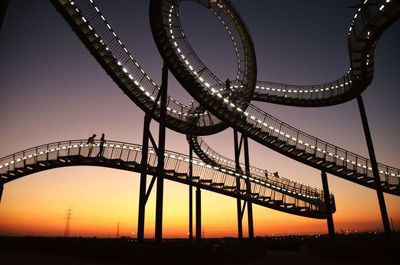 Low angle view of bridge against sky during sunset