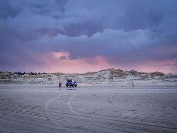 Scenic view of desert against sky during sunset