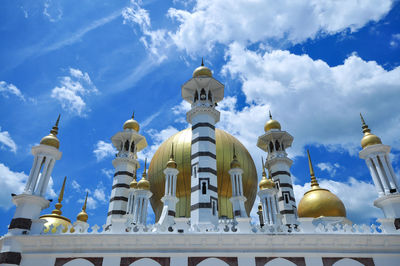 Low angle view of building against cloudy sky