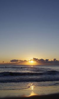 Scenic view of sea against clear sky during sunset