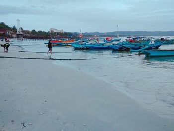 People on beach against sky