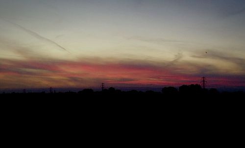 Silhouette of landscape against sky at dusk