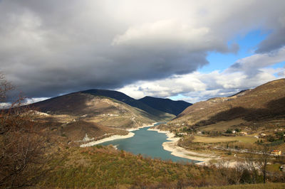 Scenic view of lake and mountains against sky