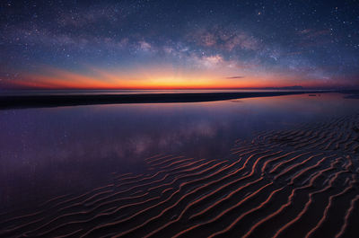 Scenic view of beach against star field