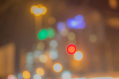 Defocused image of illuminated city at night