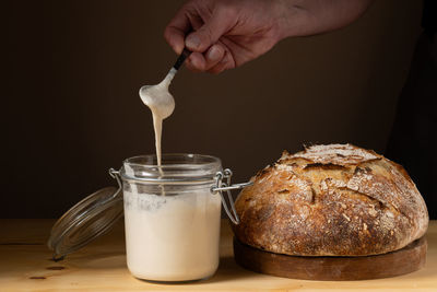 Cropped hand of person preparing food