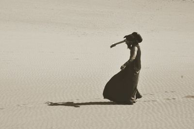 Woman standing on sand at beach