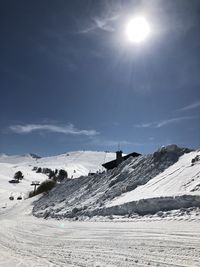 Scenic view of snowcapped mountains against sky on sunny day