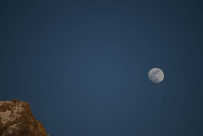 Low angle view of moon against clear sky at night