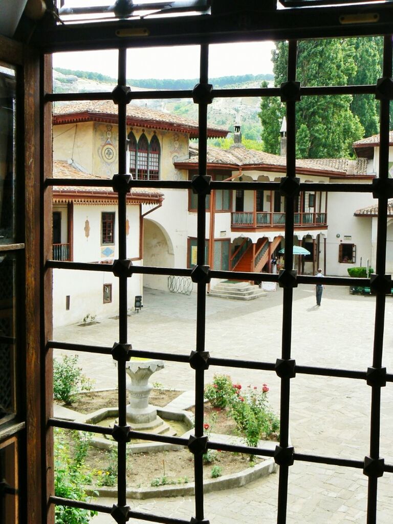 window, indoors, architecture, built structure, glass - material, transparent, building exterior, house, day, plant, no people, tree, chair, hanging, potted plant, growth, sunlight, residential structure, absence, building