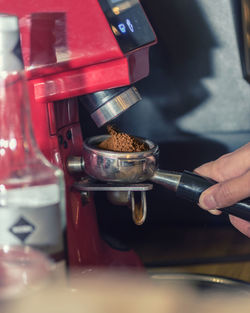 Man pouring coffee in cup