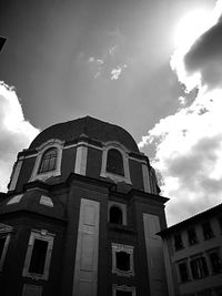 Low angle view of building against cloudy sky