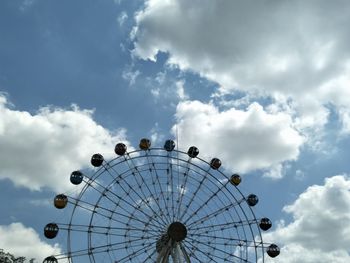 Low angle view of ferris wheel against sky