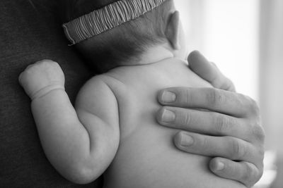 Midsection of father holding baby
