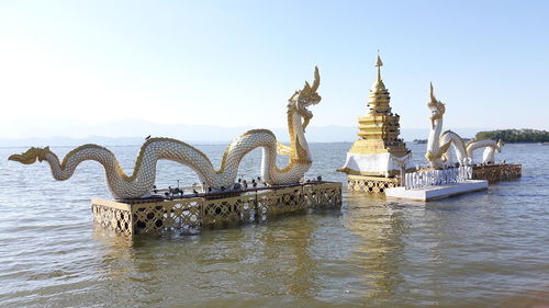 Gazebo in sea against clear sky