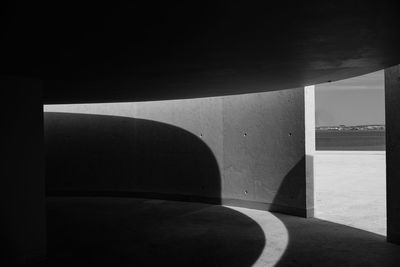 Shadow of building on footpath during sunny day