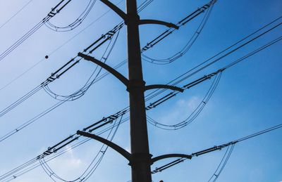 Low angle view of electricity pylon against sky