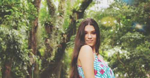 Portrait of a smiling young woman in forest