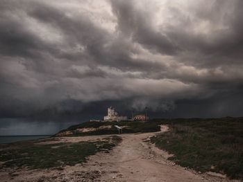 Scenic view of sea against storm clouds