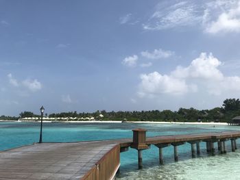 Scenic view of swimming pool by sea against sky