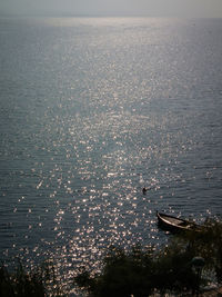 Close-up of illuminated sea against sky during sunset