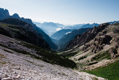 Scenic view of valley and mountains against sky