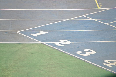 High angle view of running track with numbers in stadium