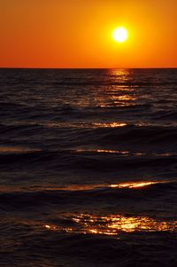 Scenic view of sea against orange sky