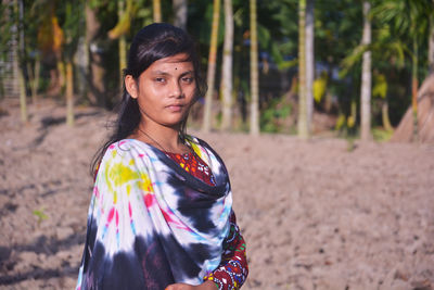 Portrait of woman standing on land
