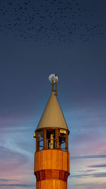 Low angle view of built structure against sky during sunset