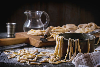 Close-up of dough with utensils on table