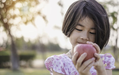 Portrait of a girl holding pink flower