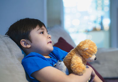 Boy looking at toy at home