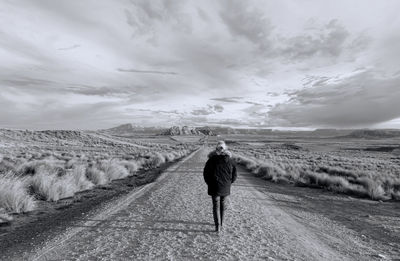 Woman walking on sand dune