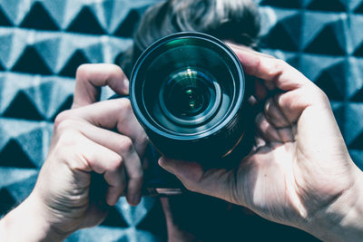 Close-up of man photographing with camera