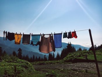 Clothes drying on clothesline against sky