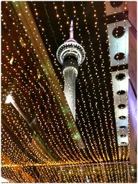 Low angle view of illuminated tower at night