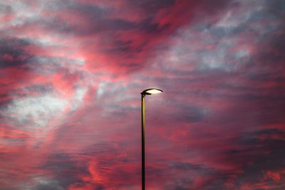 Low angle view of street light against cloudy sky