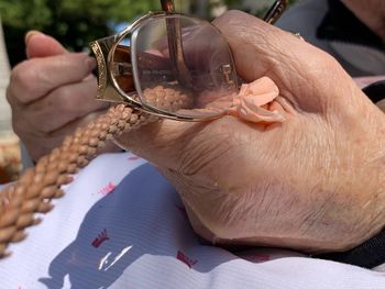 Close-up of man holding eyeglasses