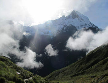 Scenic view of mountains against cloudy sky