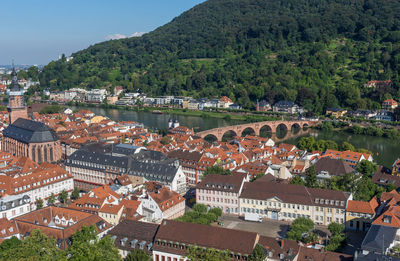 High angle view of townscape by river in city