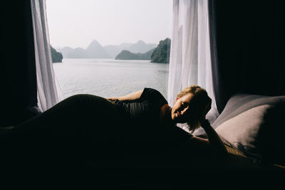 Woman relaxing by window